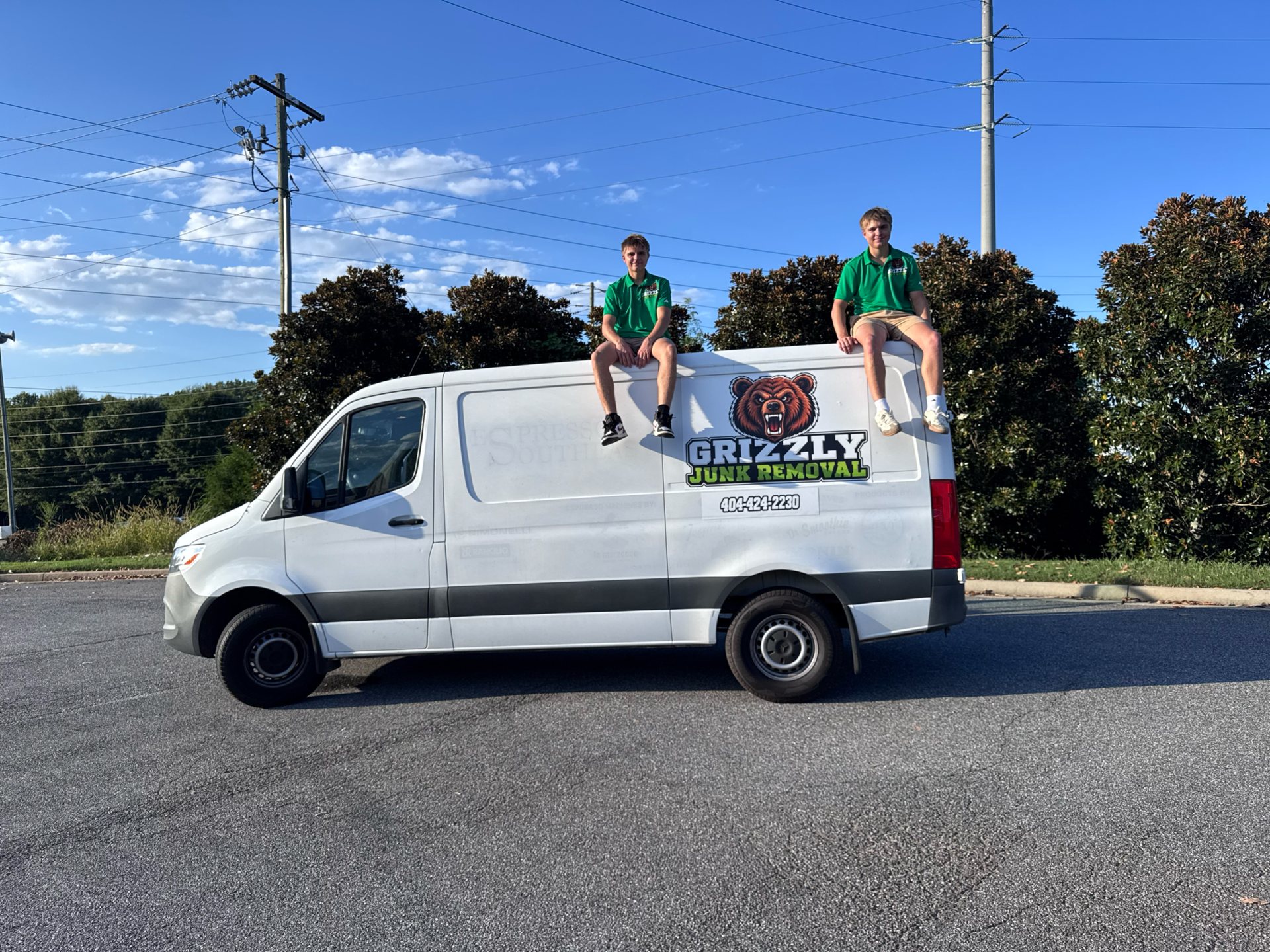 The Grizzly Junk Removal crew with their branded van