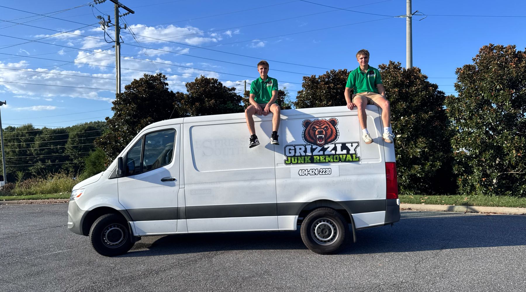 The Grizzly Junk Removal crew sitting on top of the company van