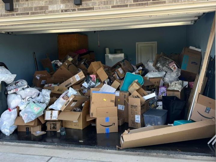 Household furniture and boxes cleared out of a garage